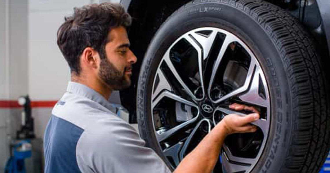Hyundai service technician working on a wheel