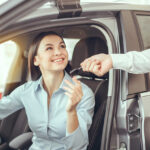 Customer receiving keys to a new car at a Hyundai dealership